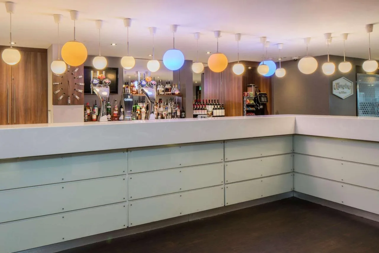 bar with blue and yellow lighting at Hampton by Hilton Birmingham Broad Street